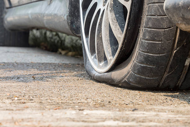 istock Car flat tire on road 525222604