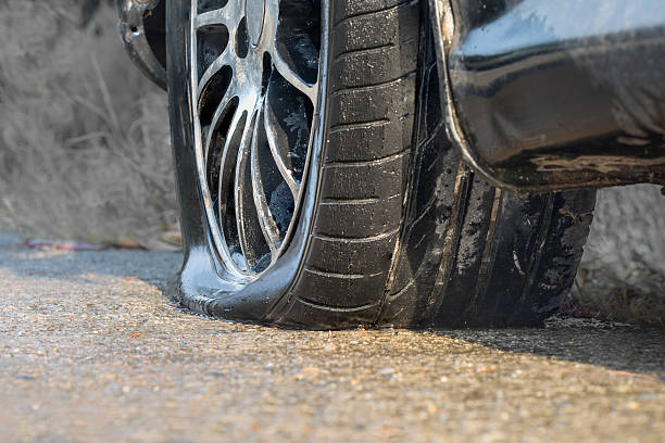 istock Car flat tire in rainy day 525222790