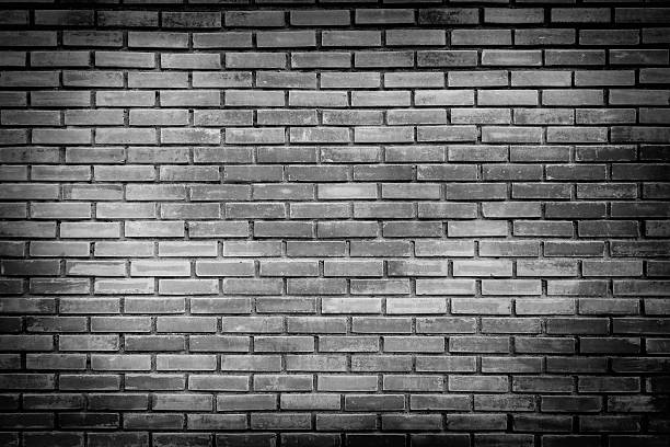 istock Black and white brick wall with black edges 525224068