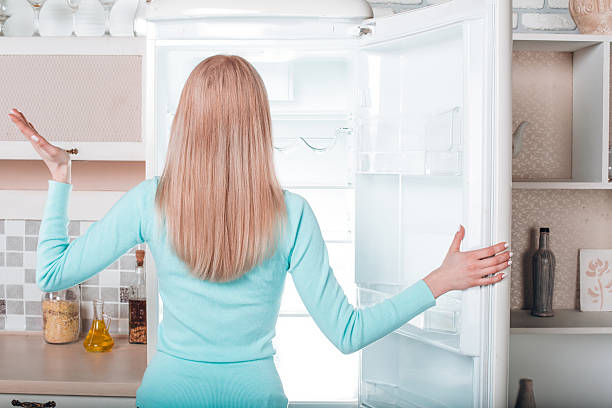 istock Young blonde at home near fridge 525224602