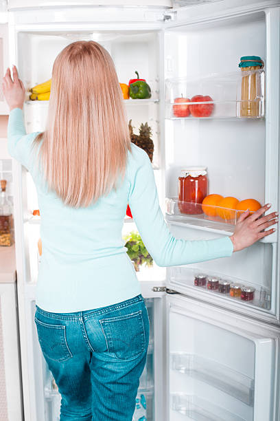 istock Young blonde at home near fridge 525224790