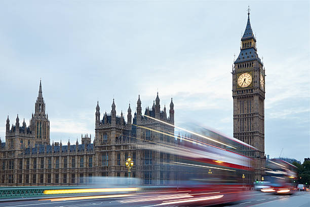 istock Big Ben, red buses passing in London 525225494