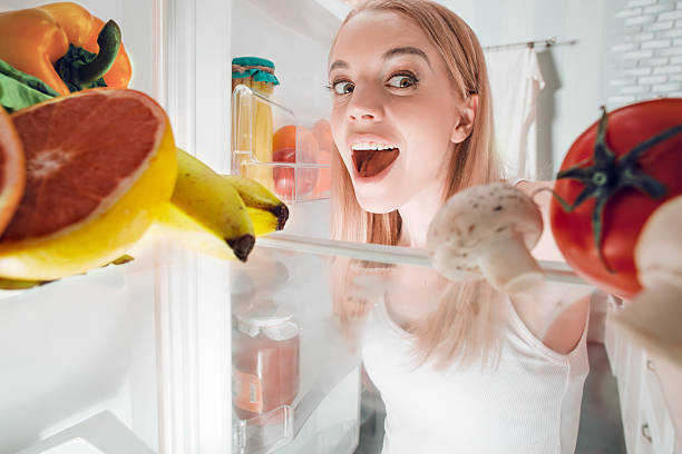 istock Young blonde at home near fridge 525227668