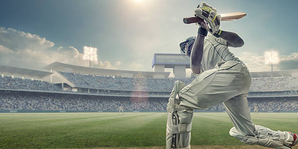 cricket schlagmann mit schläger bis nach ein paar schlägen in den ball im spiel - cricket stock-fotos und bilder