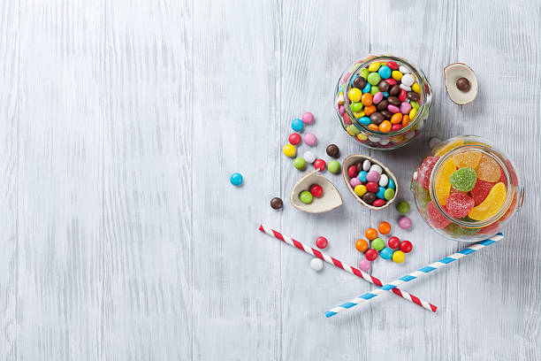 istock Colorful candies on wooden table 525228758