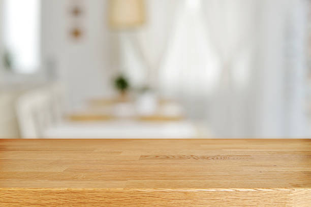 Wooden table and blurred dining room Empty wooden table and blurred dining room interior decoration background. Product display. dining table stock pictures, royalty-free photos & images