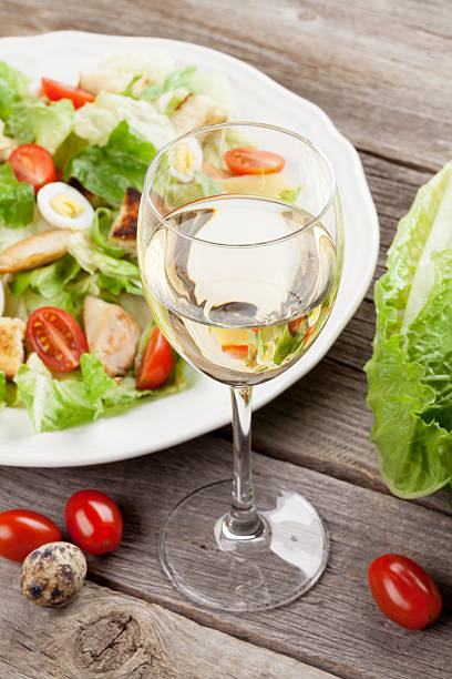 istock Fresh healthy salad and white wine 525230320