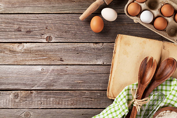 istock Kitchen table with cookbook, utensils and ingredients 525230544