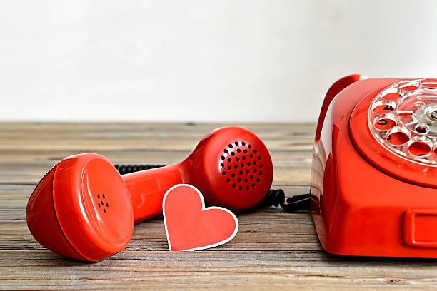 istock Old red telephone and heart shaped tag 525230930
