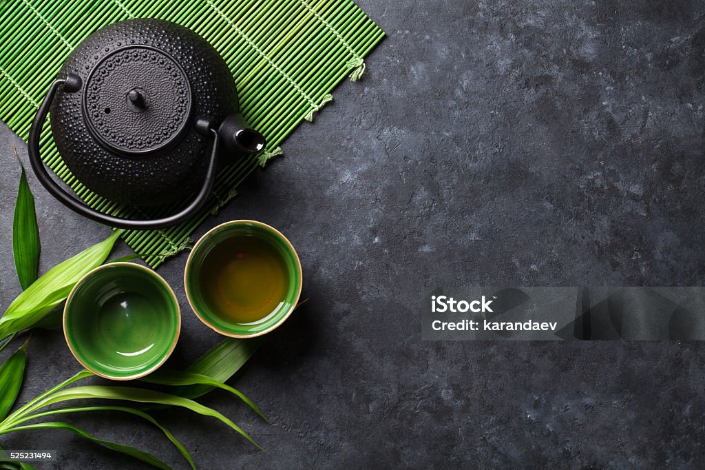 Green japanese tea Green japanese tea on stone table. Top view with copy space Green Tea Stock Photo