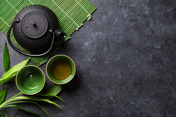 Green japanese tea Green japanese tea on stone table. Top view with copy space green tea stock pictures, royalty-free photos & images