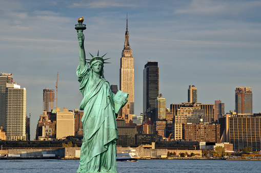 Statue of Liberty in a blue summer sky. Landmark of New York\nBlue sky background with copy space