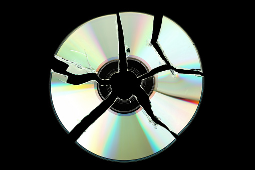 broken cd isolated on black background