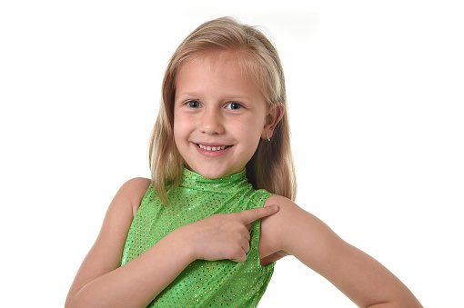 6 or 7 years old little girl with blond hair and blue eyes smiling happy posing isolated on white background pointing shoulder in language lesson for child education and body parts school chart serie