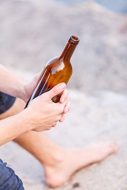 istock Male hand with wine bottle outdoor 525235652