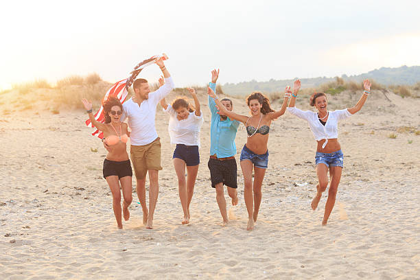 istock Group of happy young people having fun on beach together 525235854