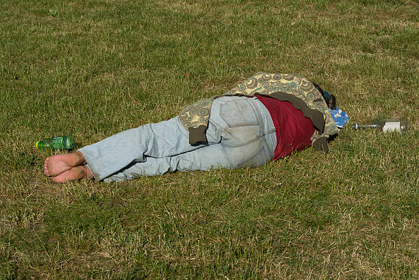 Nerd athlete lies splayed out exhausted in green grass