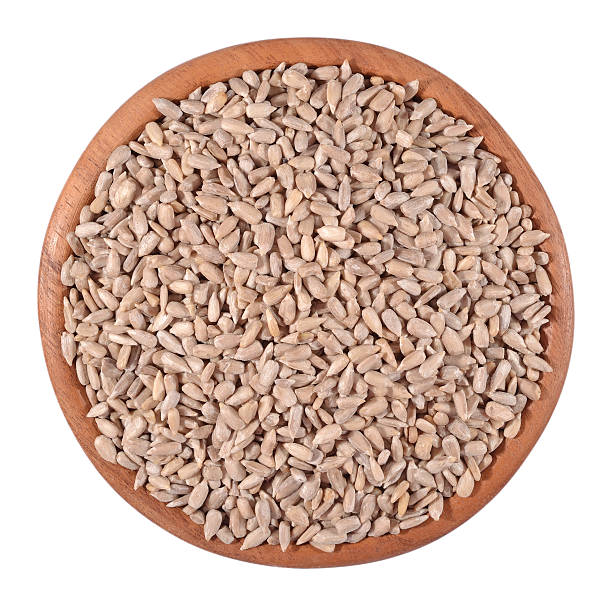 istock Cleared sunflower seeds in a wooden bowl on a white 525241511