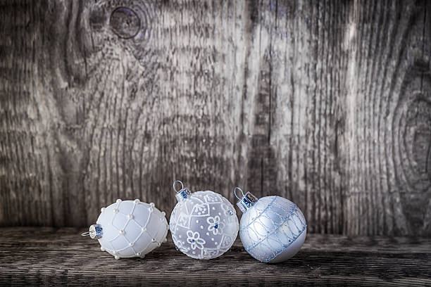 istock White christmas balls on a wooden background. 525242367