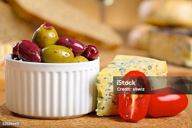 Blue Cheese And Olives On A Wooden Serving Board Stock Photo - Download Image Now - Abbey - Monastery, Appetizer, Blue Cheese