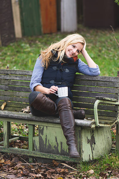 istock Smiling fashionable blonde drinking hot beverage 525245221