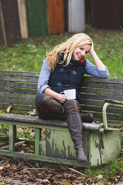 istock Smiling fashionable blonde drinking hot beverage 525245225