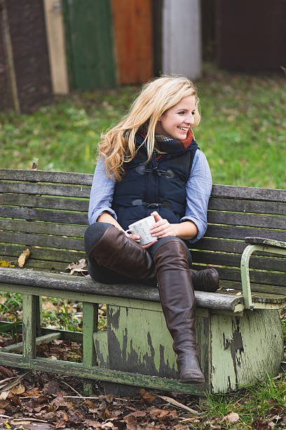 istock Smiling fashionable blonde drinking hot beverage 525245231