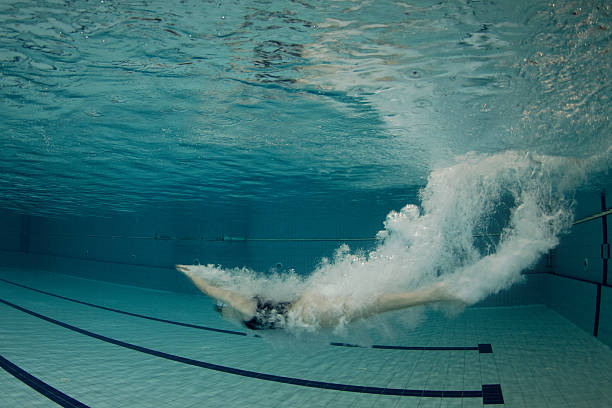 istock Attractive young woman swimming under the water surface 525245671