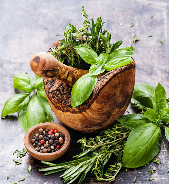 istock Fresh spicy herbs in olive wood Mortar 525246049