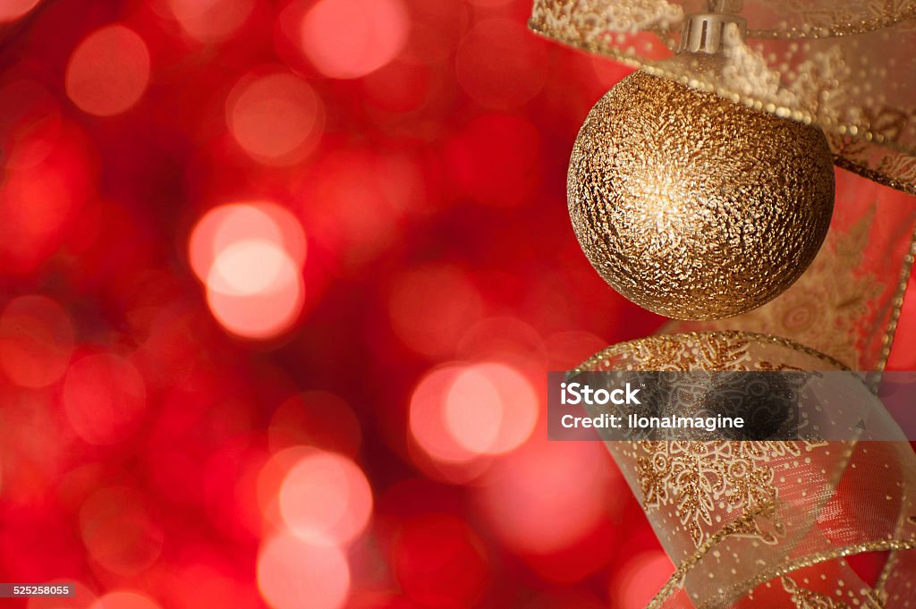 Christmas and New Year backrgound Golden New Year ball on the red bokeh background Beauty Stock Photo
