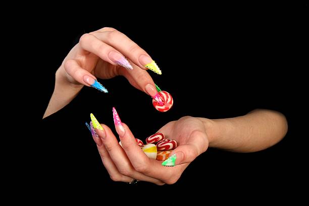istock Beautiful hands with french manicure on black background 525258633