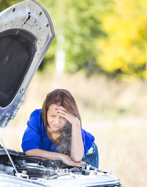 istock girl with a broken car 525258735