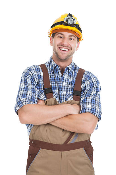 istock Smiling Male Worker Standing Arms Crossed Over White Background 525258955