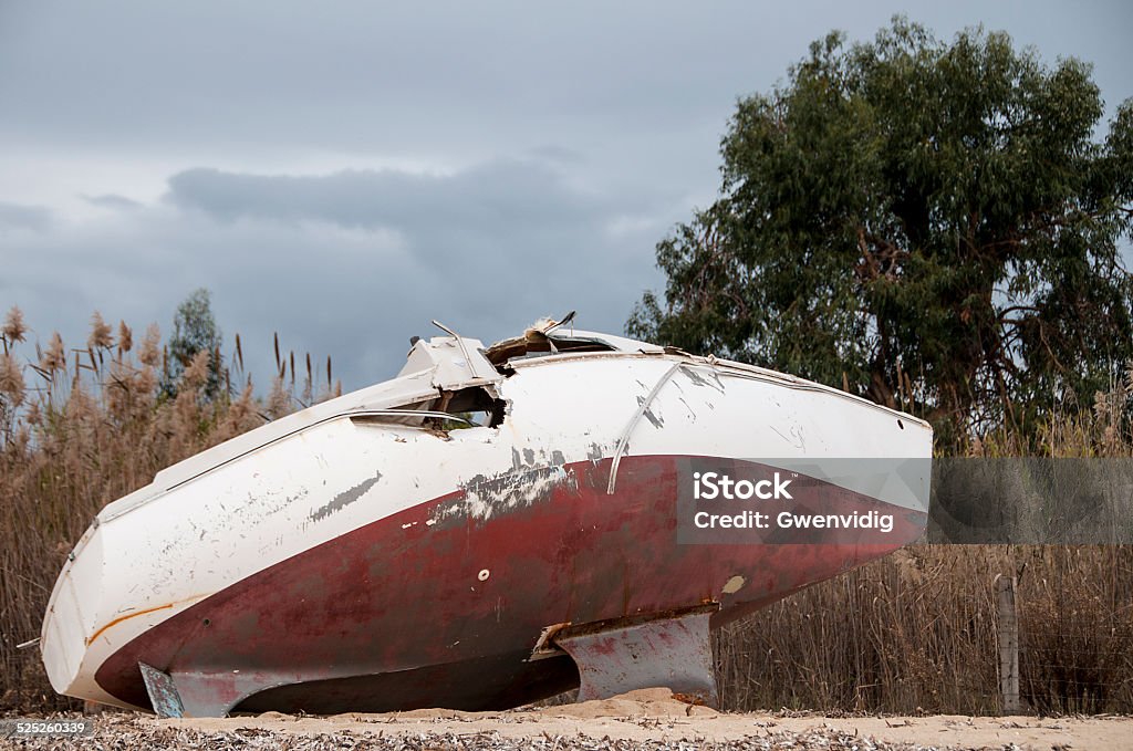 shipwreck a sailboat was thrown to the coast during a storm it is stranded pierced and dismasted on a beach Beach Stock Photo