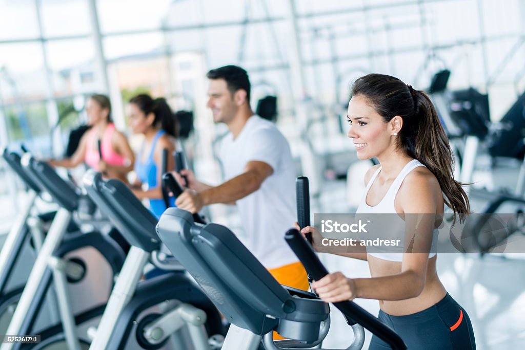 Gym people on cross trainers Group of gym people exercising on cross trainers Cross Trainer Stock Photo