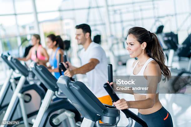 Gym People On Cross Trainers Stock Photo - Download Image Now - Cross Trainer, Smiling, Sport