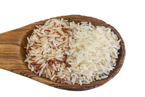 istock brown rice and white rice on wooden spoon 525271111