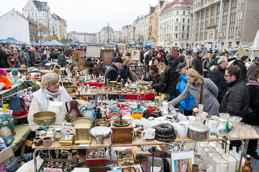 Vienna, Austria - November 15, 2014: The Naschmarkt is the most popular street market in Vienna, it started in the 16th Century. All kind of fruits and vegetables are sold there, along with exotic herbs, cheese, bread, meat and seafood. There are also many small restaurants which offer typical Viennese food, as well as international specialities. Since 1977, the market extends to include also a flea market on Saturdays. It is used by locals, but lots of tourists visit the market every year. This image shows how busy the flea market can get.