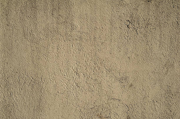 istock Texture of old wall covered with yellow stucco 525271723