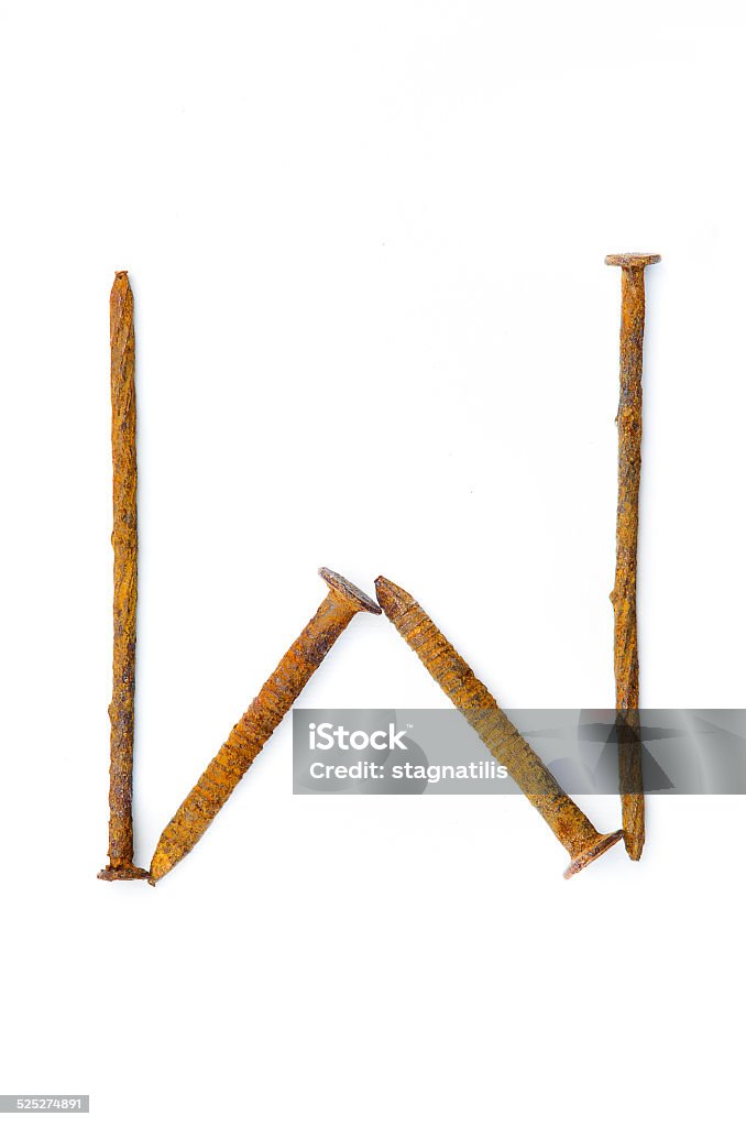 Rusty Nails W Iron letter W composed of rusted nails on white background. Alphabet Stock Photo
