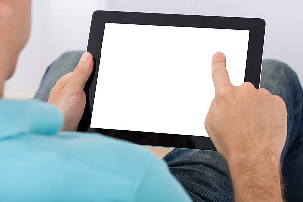 istock Man Looking At Blank Screen Of Digital Tablet 525275839