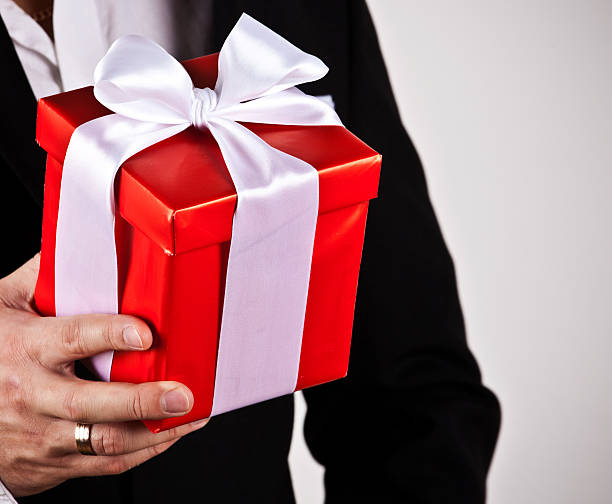 istock Close-up of businessman holding present 525275853