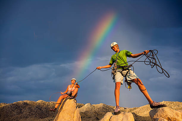 istock Husband and wife climbing team on the summit. 525275883
