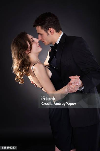 Elegant Couple Dancing Over Black Background Stock Photo - Download Image Now - Adult, Couple - Relationship, Dancing