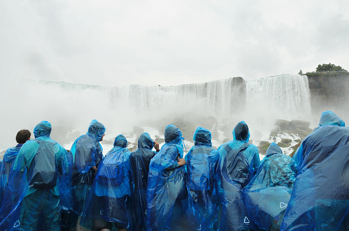Niagara Falls, Ontario, Canada - August 9, 2012: Tourists aboard Maid of The Mist get close to the falls