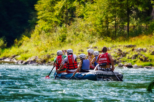 Rafting on The Dunajec River, Poland Szczawnica, Poland - August 17, 2011: Group of adult people with children rafting on The Dunajec River on inflatable boat through The Dunajec Gorge in Pieniny National Park. szczawnica stock pictures, royalty-free photos & images