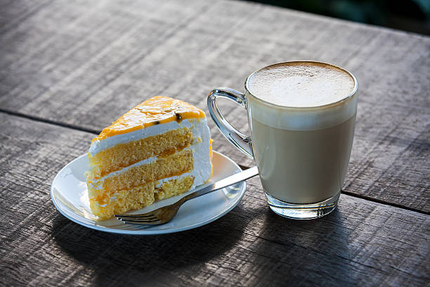 istock Cake with cup of coffee on old wood table 525298843