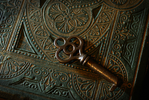 A mysterious textured book with a skeleton key.