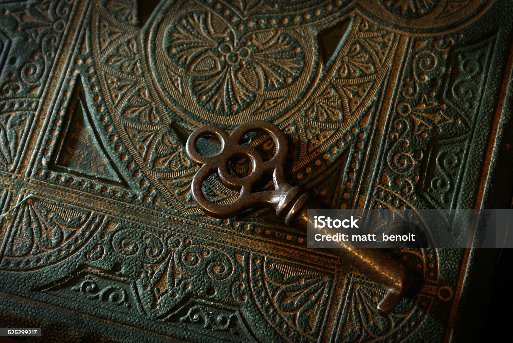 Old Mysteries A mysterious textured book with a skeleton key. Key Stock Photo