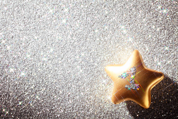 istock First Anniversary Star - Christmas Glitter Background One Silver Gold 525299343